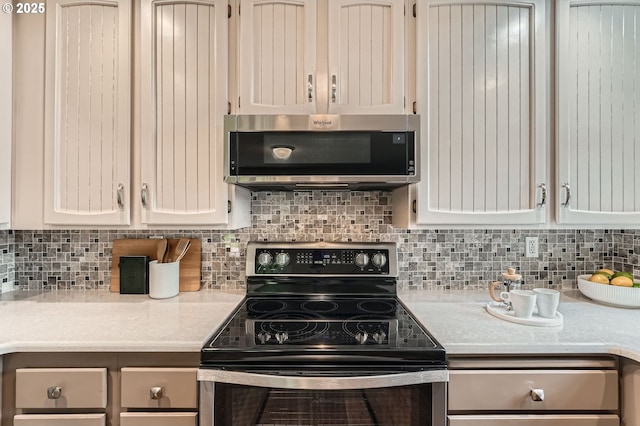 14905 SE Stevenson Dr, Vancouver, WA 98683 - kitchen featuring appliances with stainless steel finishes, light countertops, and decorative backsplash