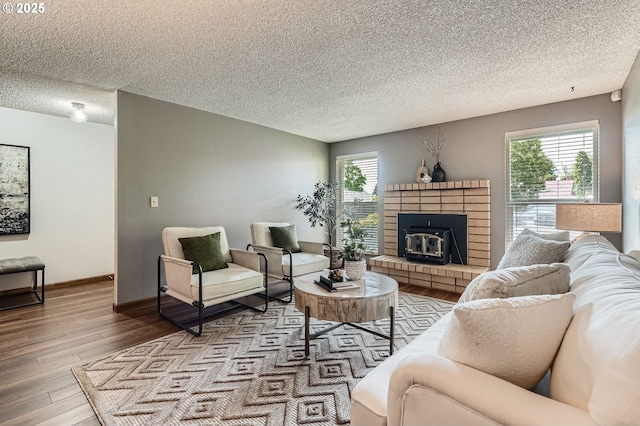 14905 SE Stevenson Dr, Vancouver, WA 98683 - living room with a textured ceiling, wood finished floors, healthy amount of natural light, a fireplace, and baseboards