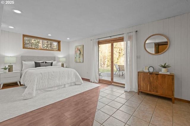 bedroom featuring access to exterior, recessed lighting, and light tile patterned floors