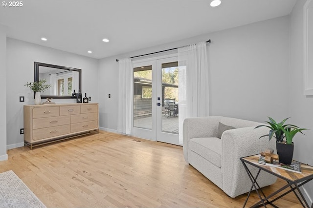 sitting room with light wood-type flooring, recessed lighting, baseboards, and french doors