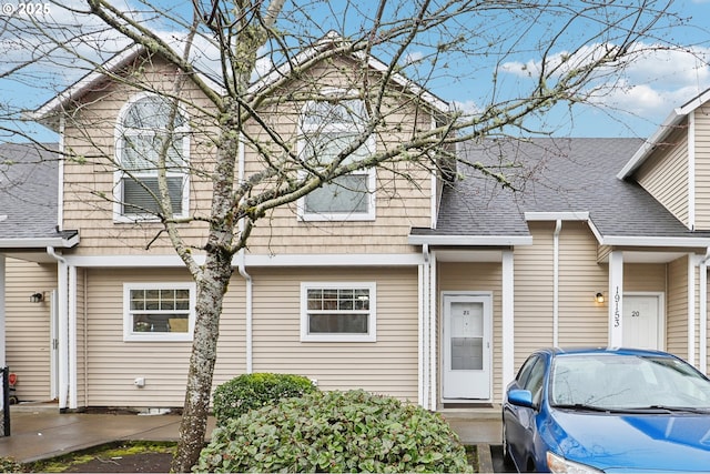 view of property with a shingled roof