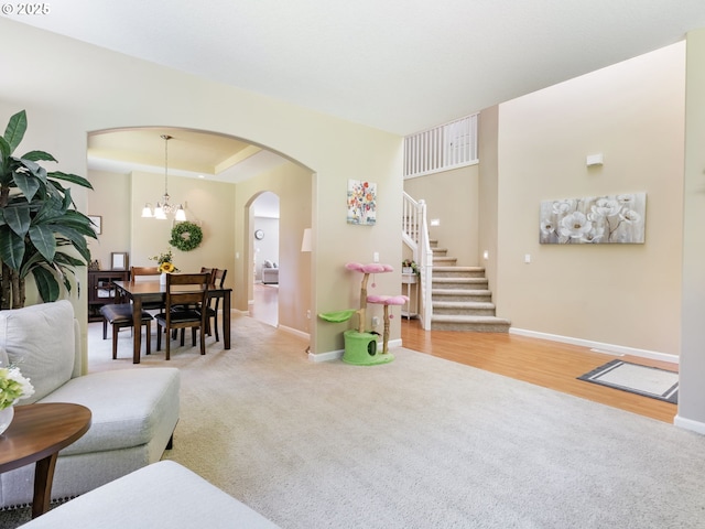 22824 NE 254th Ct, Battle Ground, WA 98604 - living area featuring baseboards, arched walkways, stairway, and light carpet