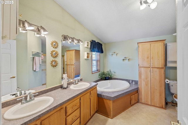 bathroom with lofted ceiling, a bath, double vanity, and a sink