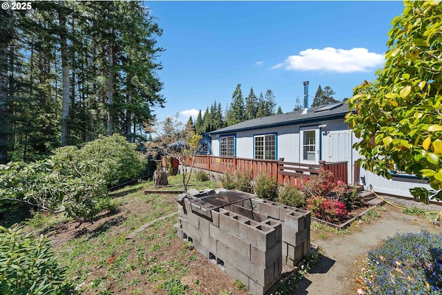 view of side of property featuring a wooden deck