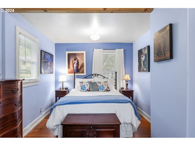 bedroom with baseboards and wood finished floors