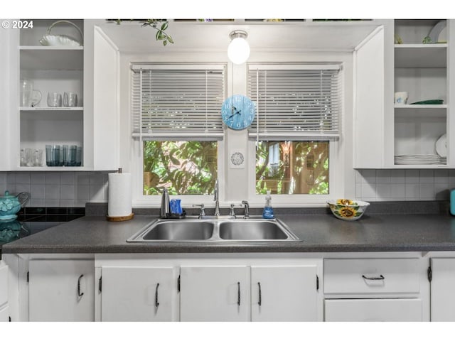 kitchen with white cabinets and dark countertops