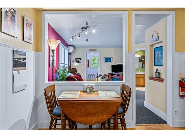dining space featuring a wall unit AC