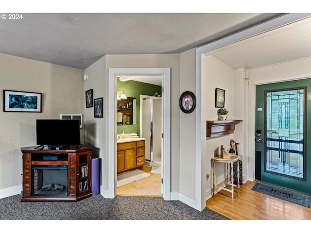 foyer with carpet flooring and baseboards
