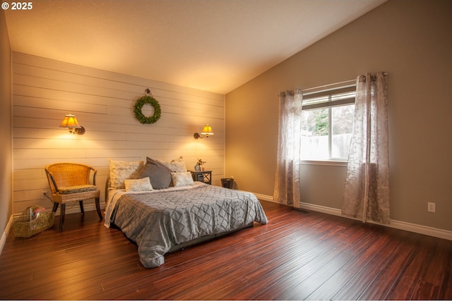 bedroom featuring wood walls, lofted ceiling, and dark hardwood / wood-style floors