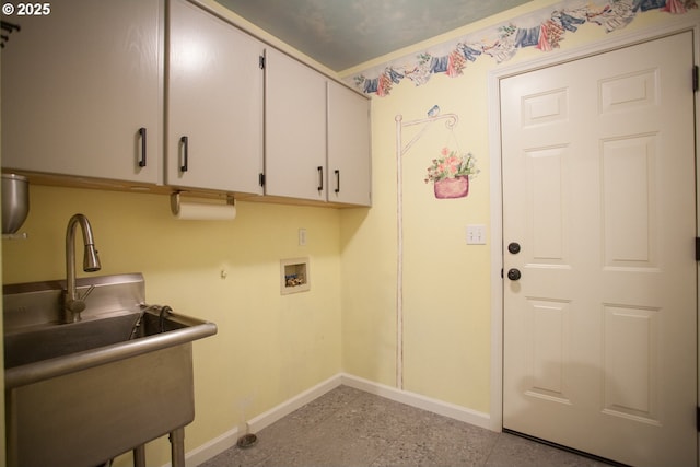 clothes washing area featuring washer hookup, cabinets, and sink