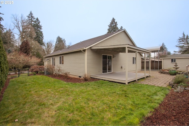 rear view of property with a deck and a yard