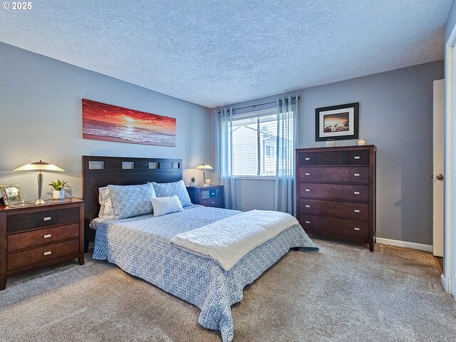 12066 SE 104th Ct Unit 20, Happy Valley, OR 97086 - carpeted bedroom with a textured ceiling and baseboards