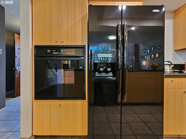 12066 SE 104th Ct Unit 20, Happy Valley, OR 97086 - kitchen featuring black appliances, tile patterned floors, dark countertops, and a textured ceiling