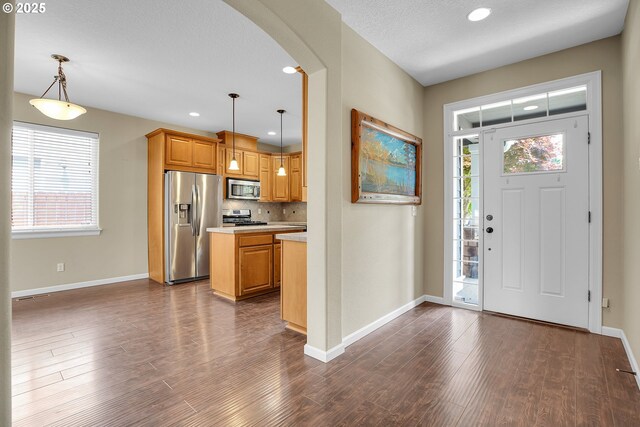 20021 Tharp Ct, Oregon City, OR 97045 - foyer with dark wood-style floors, healthy amount of natural light, arched walkways, and recessed lighting