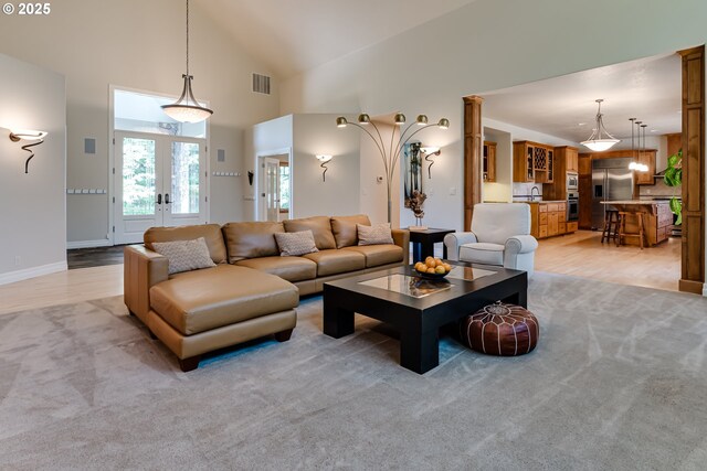 85339 Svarverud Rd, Eugene, OR 97405 - living room featuring light carpet, high vaulted ceiling, and french doors