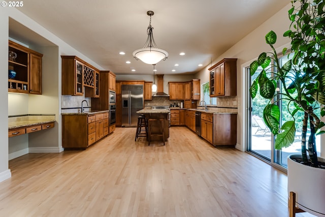 85339 Svarverud Rd, Eugene, OR 97405 - kitchen featuring built in appliances, wall chimney exhaust hood, a sink, light stone countertops, and recessed lighting