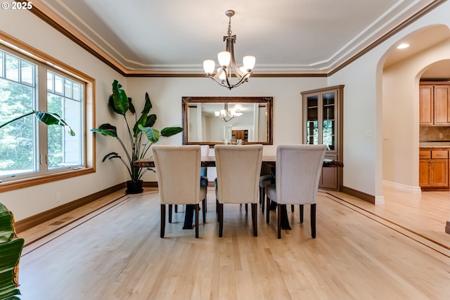 85339 Svarverud Rd, Eugene, OR 97405 - dining area featuring a chandelier, arched walkways, light wood-style flooring, baseboards, and ornamental molding