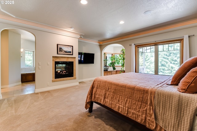 85339 Svarverud Rd, Eugene, OR 97405 - bedroom with arched walkways, light colored carpet, a multi sided fireplace, baseboards, and crown molding