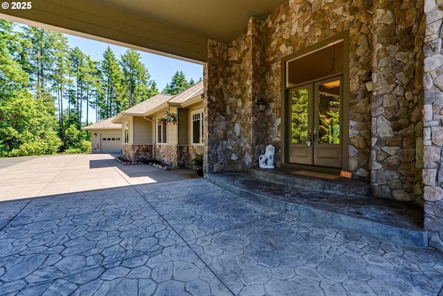 85339 Svarverud Rd, Eugene, OR 97405 - view of patio featuring french doors, driveway, and a garage