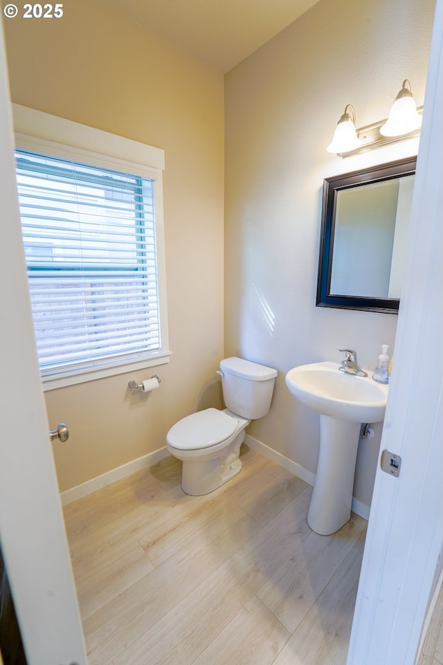 11473 SE Pleasant Valley Pkwy, Happy Valley, OR 97086 - half bath featuring toilet, wood finished floors, and baseboards