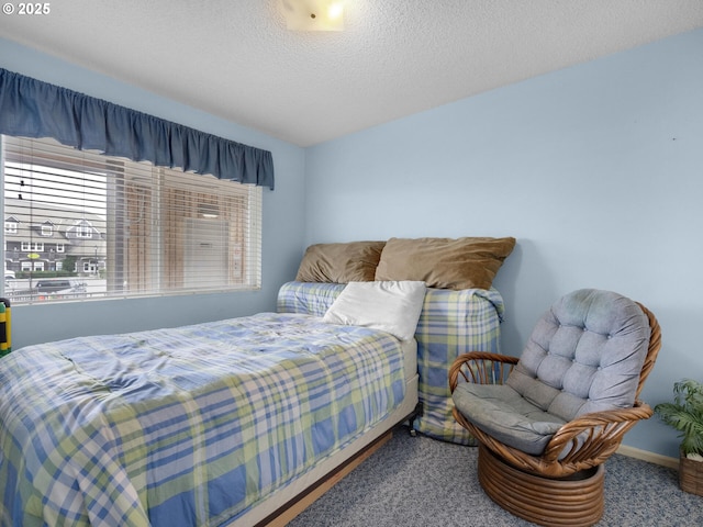 1238 N Marion Ave Unit 470, Gearhart, OR 97138 - bedroom with carpet flooring, a textured ceiling, and baseboards