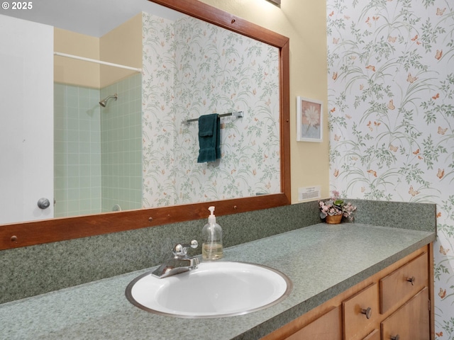 1238 N Marion Ave Unit 470, Gearhart, OR 97138 - bathroom with vanity, wallpapered walls, and a shower