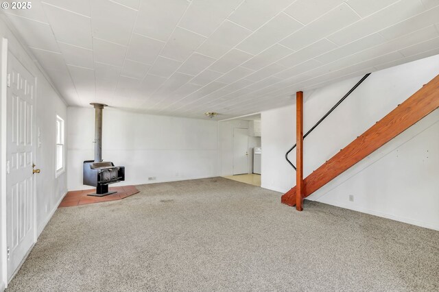 2134 Minnesota St, Eugene, OR 97402 - basement featuring carpet flooring, a wood stove, stairs, and washer / dryer