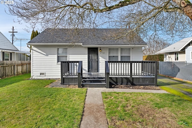 view of front of property featuring a deck and a front lawn