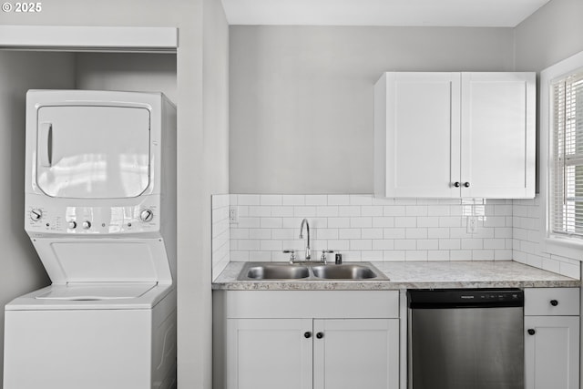 laundry area with sink and stacked washer / dryer