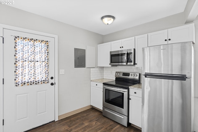 kitchen with stainless steel appliances, decorative backsplash, white cabinets, and electric panel