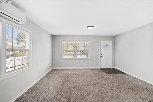 carpeted foyer with a wall unit AC