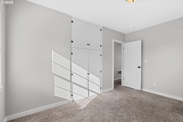 unfurnished bedroom featuring carpet floors and a closet