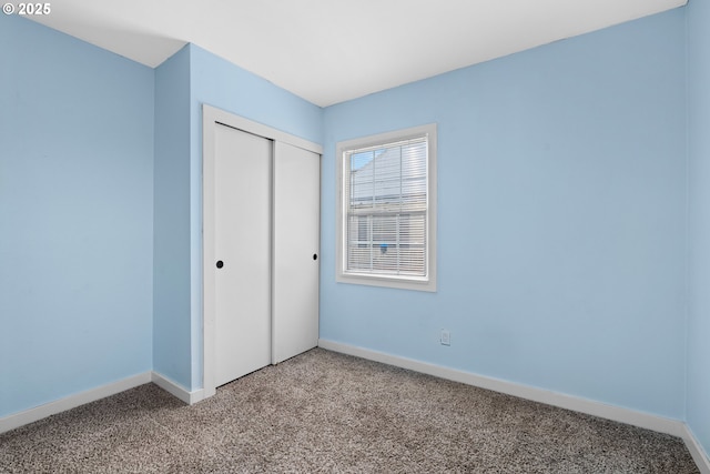 unfurnished bedroom with carpet floors and a closet