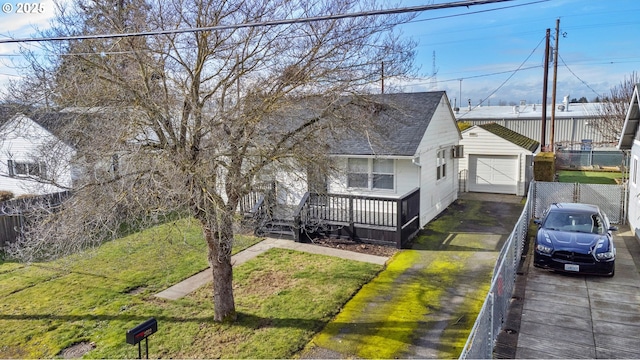 bungalow-style house with a garage, an outbuilding, and a front yard