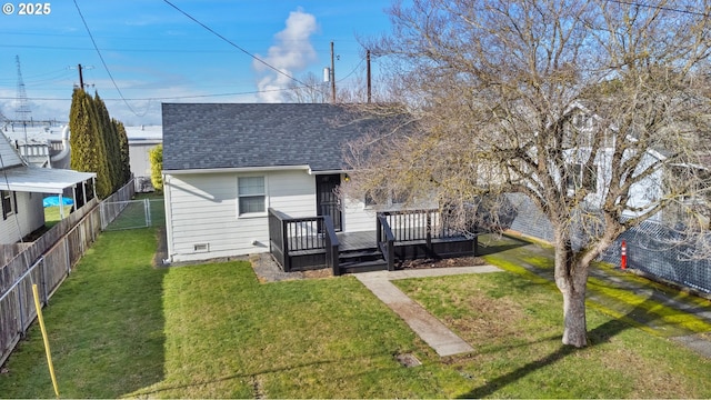 rear view of house featuring a wooden deck and a lawn