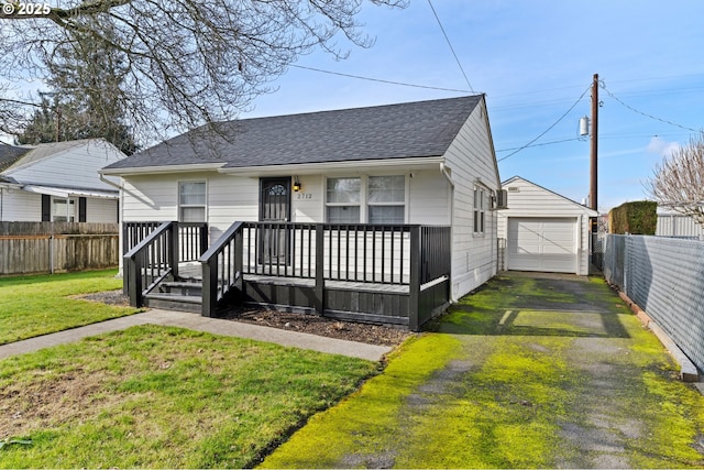 view of front of home with an outbuilding, a garage, and a front lawn