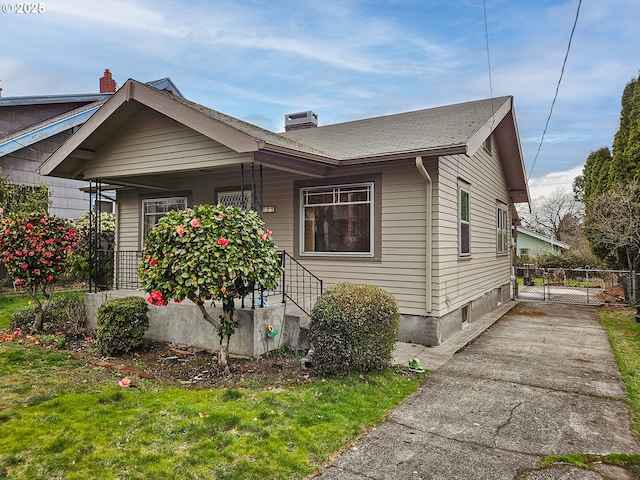 view of front of home with a porch and a chimney