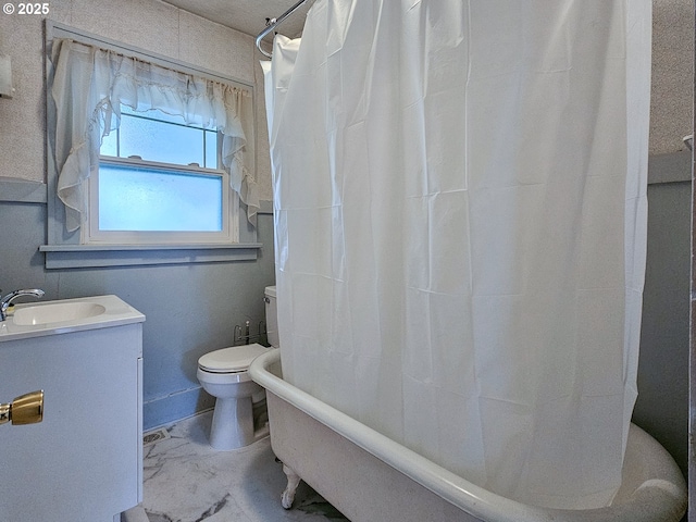 bathroom with vanity, marble finish floor, and toilet