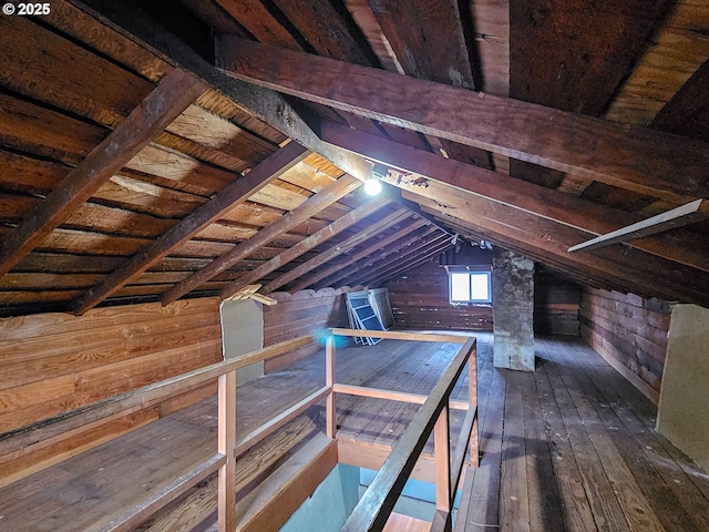 unfinished attic featuring an upstairs landing
