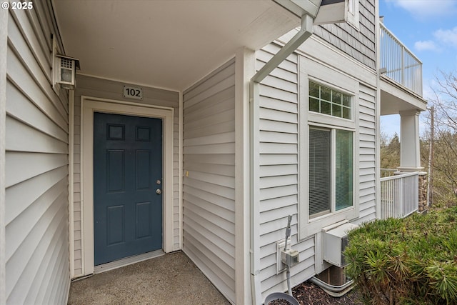 view of exterior entry featuring a balcony