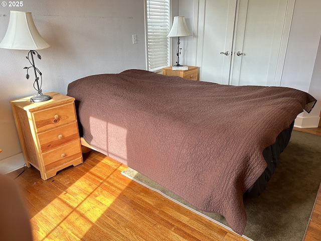 bedroom featuring baseboards and wood finished floors