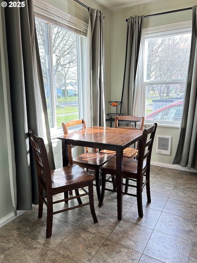 dining room with a wealth of natural light and baseboards