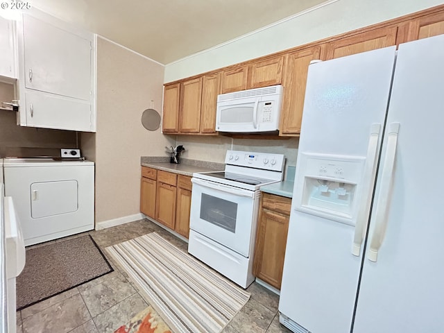 kitchen with white appliances, washer / clothes dryer, light countertops, and baseboards