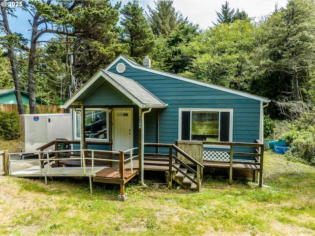 63345 Shore Edge Dr, Coos Bay, OR 97420 - view of front of house featuring a deck and a front yard