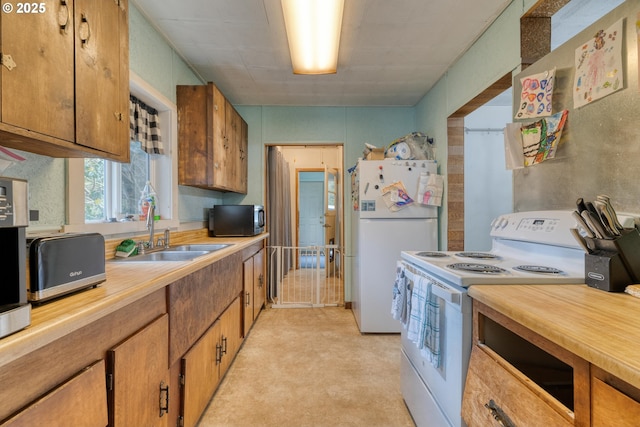 63345 Shore Edge Dr, Coos Bay, OR 97420 - kitchen featuring white appliances, a sink, and brown cabinets