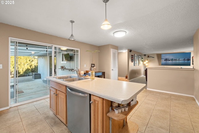 kitchen featuring decorative light fixtures, dishwasher, sink, and a center island with sink