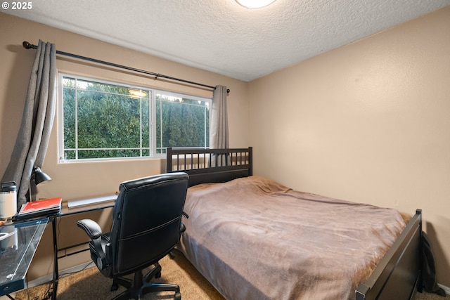 bedroom with light colored carpet and a textured ceiling