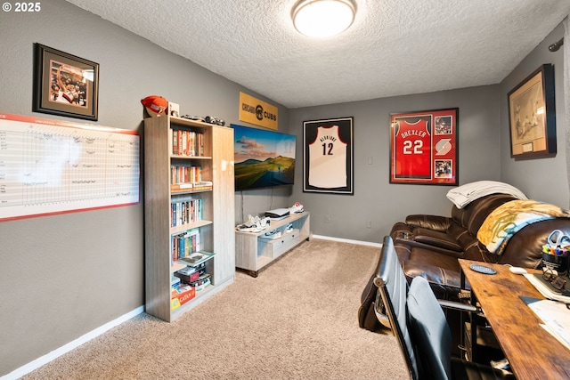 carpeted office space featuring a textured ceiling