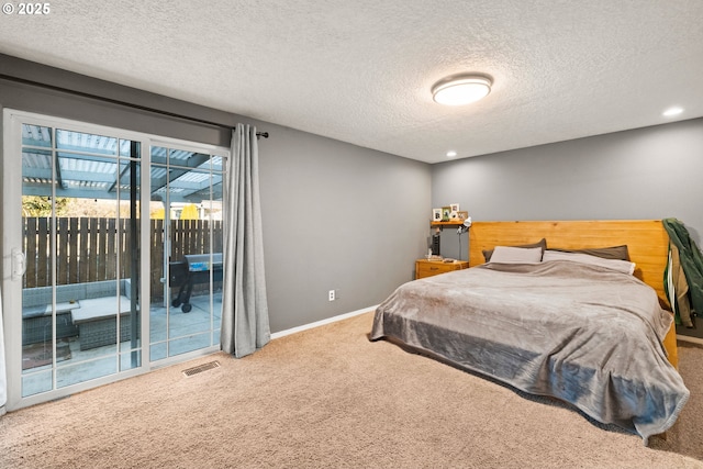 carpeted bedroom featuring access to outside and a textured ceiling