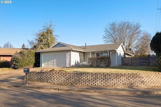 ranch-style house featuring a garage and a front yard